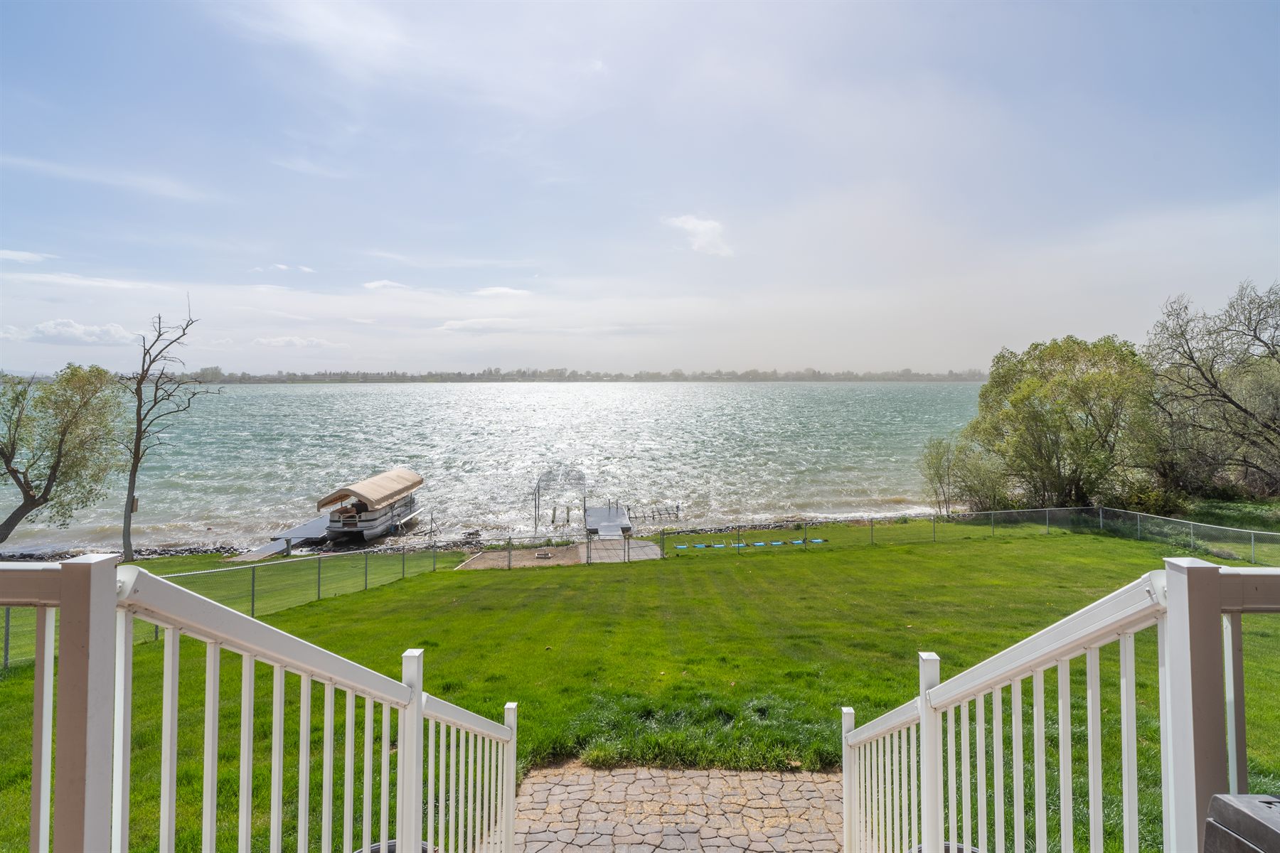 Fenced backyard between the house and the dock